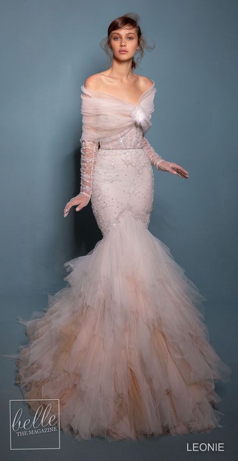 Leonie Wedding Dresses 2020 -Violet | Blush colored lace mermaid wedding dress with vintage corset bodice, sweetheart neckline, unique trumpet tulle layered skirt and paired with beautiful illusion gloves with cover up #weddingdress #weddingdresses #bridalgown #bridal #bridalgowns #weddinggown #bridetobe #weddings #bride #dreamdress #bridalcollection #bridaldress #dress See more gorgeous bridal gowns by clicking on the photo Mermaid Fit Wedding Dress, Wedding Western Dress, Mermaid Dress Hijab, Acotar Gowns, Western Bridal Dresses, Mermaid Inspired Dress, Mermaid Bridal Gowns, Victorian Theme, Wedding Inspirasi