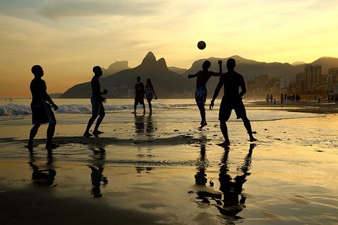 Young men play beach football as the sun sets on Ipanema beach in Rio de Janeiro. Credit: Richard Heathcote/Getty Beach Football, Brazil Beaches, Elephant Shrew, Visit Brazil, Ipanema Beach, Graffiti Photography, Rio Brazil, World Birds, Beach At Night