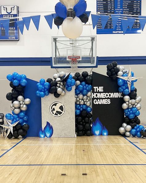 🔷🔹 U Prep Homecoming Games 🔹🔷 The Hunger Games Homecoming theme came together flawlessly. 🖲️ Blue flame gauntlet Creative Columns. Custom lit balloon garland made for their hoco backdrop with silver starbursts. Custom garland with Mylar starburst and spandex cover on backdrop rental. Color palette: black, silver, and metallic blue Backdrop Rental, Homecoming Themes, Homecoming Games, Line Love, Blue Flame, High Jump, The Hunger Games, Blue Flames, The Hunger