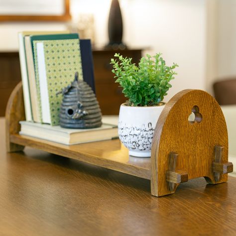 The charming Tabletop Bookshelf—a reissue of an original design created by Gustav Stickley around 1907—was featured in the Mission Collection in the 1990s. Crafted of solid oak, its most eye-catching Arts and Crafts feature is a quartet of miniature keyed tenons that ensure its durability. Use this beautiful piece on a desk, console table, or dresser to conveniently organize and display your favorite books. It's available in three of our most popular Mission Oak finishes.FROM THE ARCHIVES!An ori Tabletop Book Display, Tabletop Bookshelf, Building With Wood, Tile Top Tables, Mission Tile, Desk Console, Oak Mantel, Gustav Stickley, Woodworking Projects For Beginners