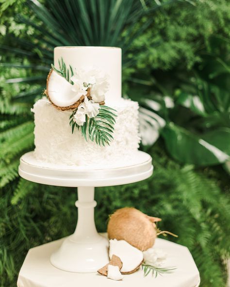 There are so many tropical details to incorporate onto your big-day dessert, but we think coconuts are an appropriate (and delicious) addition. Beverly's Bakery added shards of the fruit onto this all-white confection, along with florals and greenery from Inessa Nichols Design. For a cohesive touch, Detailed Touch Events included coconuts on the table below. Tropical Wedding Balloon Arch, Simple Wedding Cake Tropical, Tropical Simple Wedding, Simple Summer Wedding Cake, Simple Tropical Wedding Cake, Simple Hawaii Wedding, Wedding Cake With Tropical Flowers, Simple Beach Wedding Cake, Island Wedding Theme