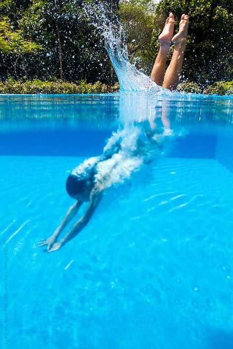 A young asian woman is diving head-on into the pool. The image captures her half in and half out of the water. Metabolic Meals, Swimming Pool Photography, Swimming Aesthetic, Bio Pool, Swimming Photos, Swimming Pictures, Diving Pool, Women's Diving, Pool Photography