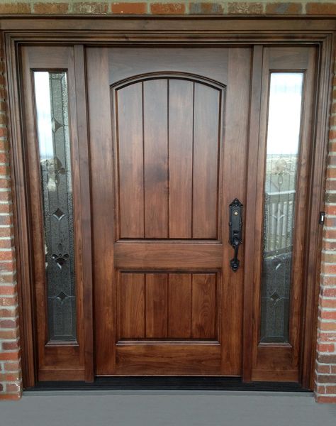 Leaded glass sidelights add a distinctive flair to this select alder door unit with arched top rail and raised panels with v-grooves.  Glass by Scottish Stained Glass. French Country Doors Entrance, Tradition House, House Entry Doors, Door Renovation, Exterior Doors With Sidelights, Brown Front Doors, Cabin Storage, Double Front Entry Doors, Entry Door With Sidelights