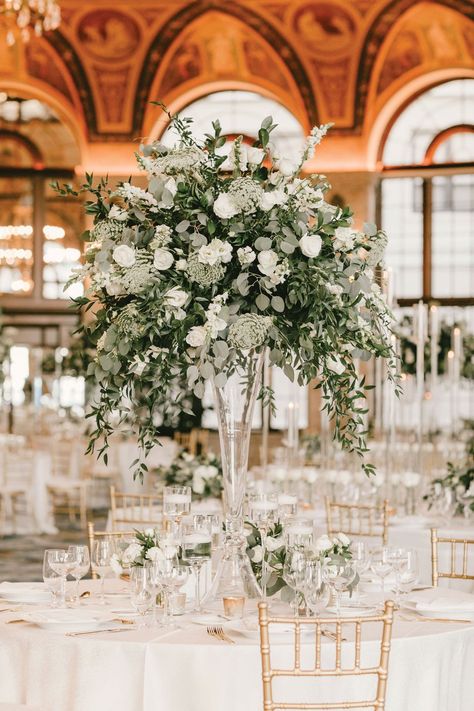 Flower Decorations For Wedding Reception, Banister Flowers Wedding, White Flowers And Greenery Wedding Reception, Winter Greens Centerpiece, High Centerpiece Wedding, White Rose Centerpiece Wedding, White Flower Arrangements Wedding, Tall Floral Centerpieces Wedding, Tall Centerpiece Wedding