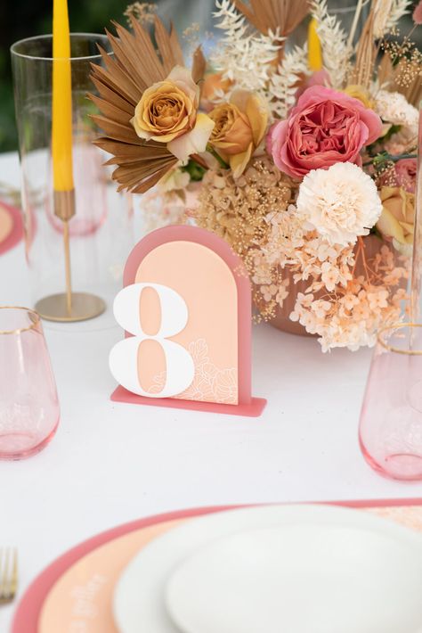 Pink and Peach Wedding Reception Table Numbers and Boho Tan Centerpiece Pink And Peach Party, Fun Table Numbers, Colorful Wedding Signs, Cool Table Numbers, Embroidered Table Numbers, Colorful Table Numbers, Tan Centerpiece, Pink Orange Beige Wedding, Modern Colorful Wedding Signage