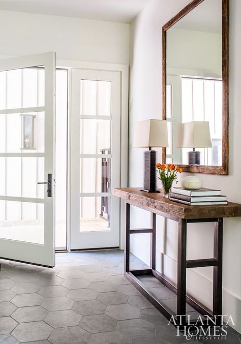 Custom hexagonal slate tiles, designed by Sheehan, add a natural and functional stone element to the minimal foyer and mudroom. Entryway Tile, Foyer Flooring, Entryway Flooring, Harrison Design, Farmhouse Entryway, Hallway Design, Hal Decor, Foyer Decorating, Foyer Design