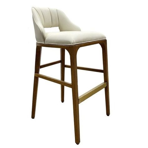 The Inga Bar Stool, covered in Endurance Sand fabric, has an upholstered back and seat that sits nimbly atop a solid white-oak frame in a morel brown finish. The paleness of the fabric and the warmth of the wood are contrasting elements. A brass kick plate on the front rung in a brushed brass finish serves a purpose and brings a bit of brightness to the design by Aimee Kurzner.