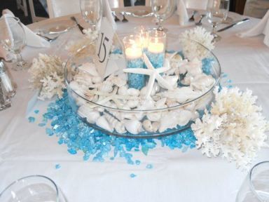 Beach Centerpieces and wedding reception decor with seashell, candles, and aqua jewels Love this underwater idea diy for an aquarium or beach design. Seashell Candle Centerpiece, Beach Wedding Table Settings, Beach Theme Centerpieces, Beach Themed Wedding Decorations, Beach Centerpieces, Beach Wedding Tables, Themed Wedding Decorations, Beach Wedding Decorations Reception, Beach Wedding Centerpieces