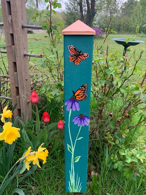 Hand painted decorative garden post for my mom on Mother’s Day. Each side has a different painting. Copper fence topper. Fence Post Painting, Painted Fence Posts, Painted Mailbox Post, Garden Posts Decorative, Painted 4x4 Posts, Painted Wooden Garden Stakes, Peace Posts Garden, Flower Painted Fence Garden Art, Fence With Flowers Painting