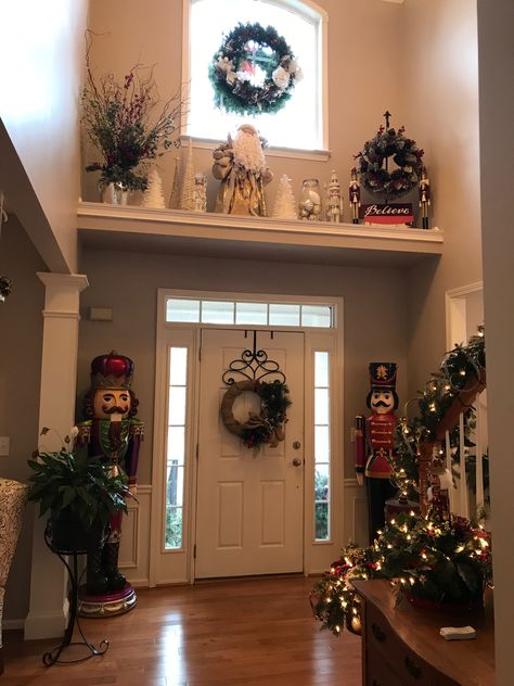 Decor Ideas For High Ledges, Battery Powered Christmas Tree, Foyer Window Ledge Decor, Vaulted Shelf Decor, Decorating Above Doorways, Plant Ledge Christmas Decorating, High Shelf Christmas Decorating, How To Decorate Ledge Above Front Door, Christmas Decor High Ceilings