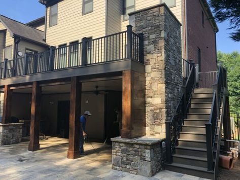 A stunning pool surrounded by a two-tier deck, featuring a cozy fireplace for a warm and inviting outdoor escape. 2 Story Deck With Pool, Fireplace Under Deck, Two Tier Deck, 2nd Story Deck, Hot Tub Deck Design, Second Story Deck, Stone Porches, Under Deck, Deck Fireplace