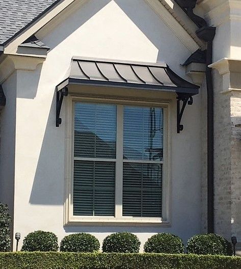 The Bronze Juliet Awning with the Lazy Scrolls Corner Awnings Over Doors, Second Story Overhang, Window Awnings Exterior Modern, Curved Metal Awning, Iron Awnings Over Doors, Bay Window Awnings Exterior, Modern Awnings For Windows, Window Canopy Exterior Modern, Metal Awning Over Window