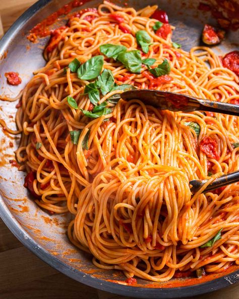 If you want something spicy, but are short on time, spaghetti arrabbiata is the answer to "what's for dinner?" Spicy cherry peppers give this dish the perfect amount of heat, while crushed tomatoes and garlic form the base of the sauce. Toss it all with spaghetti and hand-torn basil, and you've got a dish on your table in under 30 minutes. #italianrecipe #pasta #easydinner #tomatosauce #spicypasta Spagaties Recipe, Spaghetti Recipes Spicy, Spicy Spaghetti Recipes, Spicy Spaghetti Sauce Recipe, Spicy Tomato Pasta Sauce, Wedding Spaghetti, Scarpetta Spaghetti Recipe, Spicy Tomato Basil Pasta, Easy Chicken Lasagna Recipe