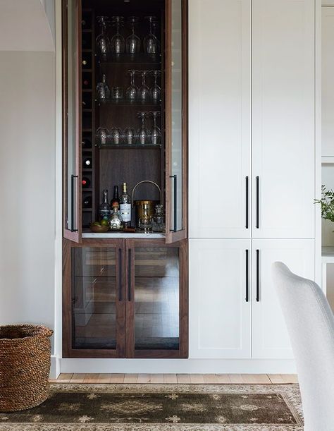 Pro tip: Integrating your bar right into your pantry area is a stylish way to save on space. The dark wood cabinet offers a dash of contrast and give it a distinct presence in the kitchen. | Photographer: Kim Jifferey | Designer: Barbara Wigmore Stand Alone Pantry, Dark Wood Cabinets, Condo Kitchen, Vintage Bar Carts, Built In Bar, Serving Drinks, Wood Bar, Kitchen Reno, Bifold Doors