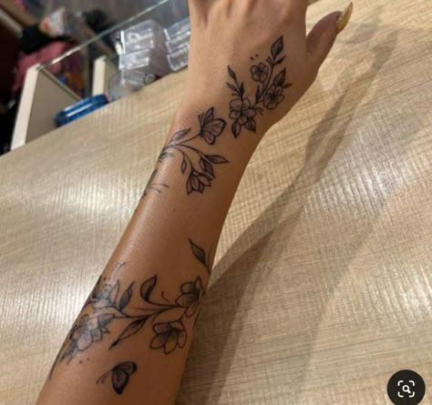 Tattoos With Deep Meaning For Black Women, Hand Tattoos Wrap Around, Cute Outline Tattoos For Women, Tiger Lily Vine Tattoo, Arm Sleeve With Small Tattoos, Floral Wrap Around Tattoo Forearm Color, Hibiscus Flower Back Tattoos, Unique Flower Tattoos For Women, Thigh Tats For Women Meaningful