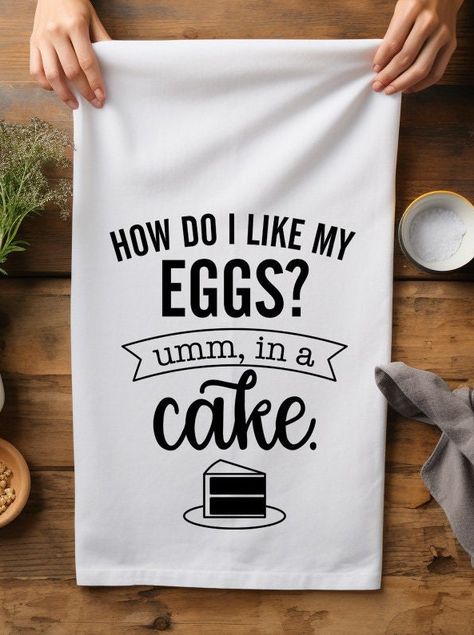 Add a dash of humor and charm to your kitchen with our delightful flour sack towel that boldly declares, "How Do I Like My Eggs? Umm, in a Cake." This towel is perfect for baking enthusiasts and cake lovers alike, making it a fantastic addition to any kitchen decor. Premium Quality Material: Crafted from 100% pure cotton, this flour sack towel is soft, absorbent, and durable. Perfect for drying dishes, cleaning up spills, or as a decorative piece. Whimsical Design: The fun and quirky quote is printed with high-quality, eco-friendly ink that is designed to withstand countless washes without fading. Generous Size: Measuring 28 x 28 inches, this towel provides ample coverage and versatility for all your kitchen needs. Easy Care: Machine washable and dryer safe, making it convenient and easy t Dish Towel Ideas, Tea Towel Svg Free, Yea Towels Cricut, Cricut Kitchen Towels Tea, Cricut Dishtowel Ideas, Cute Tea Towel Sayings, Funny Tea Towels Svg, Funny Tea Towels, Funny Note