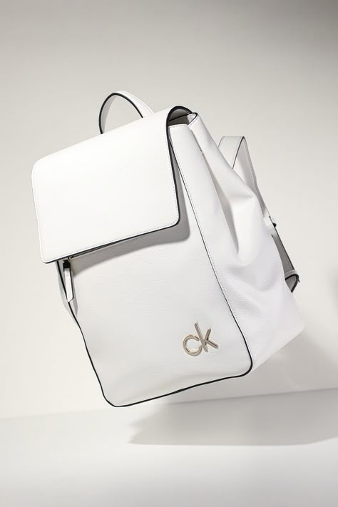 With careful handling and proper care, it will accompany you for years and will always be an #eyecatcher thanks to the colour. This one by #CalvinKlein is especially practical because it has wide, adjustable shoulder straps and several inner and outer pockets. The contrasting piping on the edges emphasises the shape and the colour. What a pure #beauty! Name Brand Purses, Pastel Notebook, Biker Girl Outfits, Brand Purses, Product Visualization, Steampunk Leather, Expensive Bag, Kawaii Bags, White Backpack