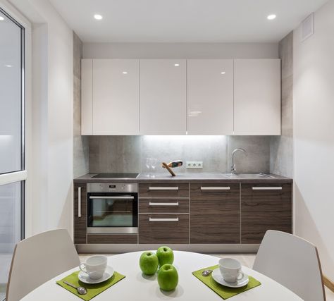 White single wall kitchen featuring a stylish kitchen counter and a small white dining nook. Single Wall Kitchen Layout, One Wall Kitchen Layout, Single Wall Kitchen, High Gloss Kitchen Cabinets, Gloss Kitchen Cabinets, One Wall Kitchen, High Gloss Kitchen, Kitchen Gallery Wall, Kabinet Dapur