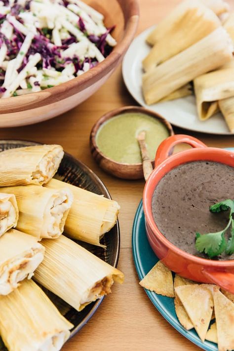 Let's face it — hosting a holiday meal is a lot of work, usually relegated to one or two people spending hours in the kitchen. But if the point of the holidays is to spend more time with friends and family, why not make Christmas dinner an all-hands-on-deck affair instead? Making tamales is a Christmas tradition in many Mexican households, and a tamale party is the perfect way to have everyone pitch in to make a special meal together. Tamale Party, Mexican Christmas Food, Christmas Dinner Ideas, Authentic Mexican Recipes, Tamale Recipe, Chile Poblano, Christmas Eve Dinner, Mexican Christmas, Christmas Menu