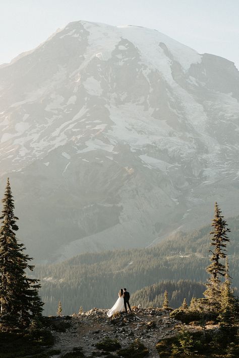 Picture it: you and your loved one, surrounded by the breathtaking beauty of Mount Rainier National Park, exchanging vows amidst the stunning alpine meadows at sunset! This couple celebrated their micro wedding with family on day one, and spent day two hiking over 1,000 feet of elevation for these incredible views. Check out the blog to discover why this Washington elopement is the ultimate adventure wedding destination! Elopement Wedding Mountain, Wedding Pictures In Mountains, Small Wedding In The Mountains, Mount Rainier National Park Elopement, Yellowstone National Park Elopement, Mt Rainer Elopement, Mount Rainier Engagement Photos, Elope Mountain Wedding, Mt Rainier Wedding