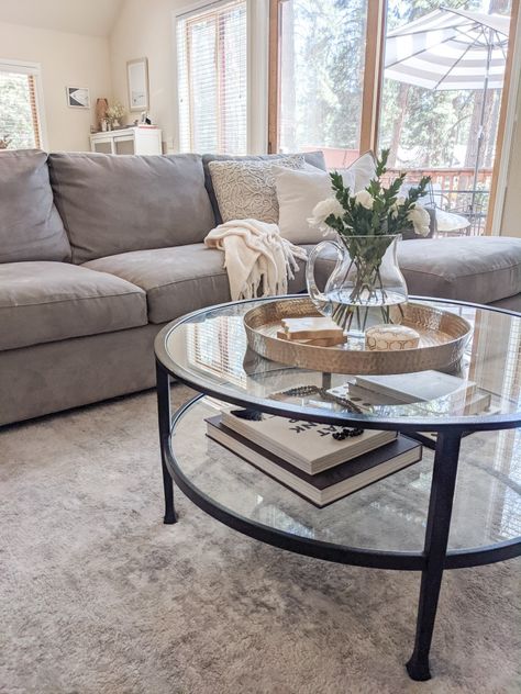 Coffee Table With Grey Sectional, Black Glass Coffee Table Living Room, Circle Glass Coffee Table Decor, Grey Couch With Coffee Table, Black Couch Coffee Table, Black Glass Table Living Rooms, Glass Table Living Room Decor, Grey Couch Coffee Table Ideas, Living Room Black Table