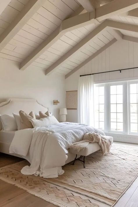 Discover 25 breathtaking vaulted ceiling bedroom ideas that will transform your sleeping space into an architectural masterpiece. Each design showcases unique ways to elevate your bedroom's aesthetic, blending style and spaciousness. From rustic wooden beams to modern lighting fixtures, these inspirations cater to diverse tastes, ensuring your bedroom becomes a serene and stylish sanctuary. Perfect for those looking to revamp their bedroom with a touch of elegance and grandeur. Vaulted Ceiling Bedroom With Beams, Bedroom Vaulted Ceiling Beams, Ceiling Beams In Bedroom, Beams In Bedroom Ceiling, Bedroom Vaulted Ceiling Lighting, Vaulted Ceiling Bedrooms, High Windows In Bedroom, Wooden Beams Ceiling Bedroom, Lighting For Cathedral Ceilings