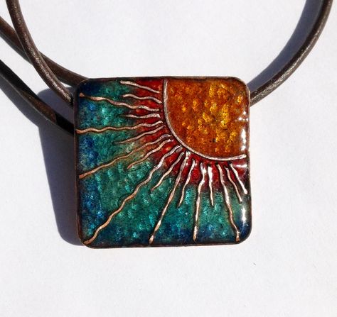 A lovely, sunny pendant 30mm square made from pure copper, which I have enamelled using transparent jewellery enamels.  I have cut and shaped fine copper wire to depict sun-rays and melted them into clear enamel, before building up the vibrant colours...this piece has been fired about 8 times to achieve depth of colour. A natural leather thong has been added with clasp...approx.18 ins long. A real head-turner!! Enameling Jewelry, Cloisonne Enamel Jewelry, Copper Jewellery, Amulet Necklace, Fused Glass Pendant, Enameled Copper, Square Pendant, Enamels, Enamel Earrings