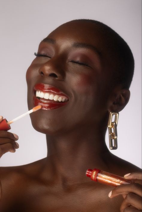 Portrait of model Ebony Ohen, photographed by Ikechukwu Dike. Fenty Beauty, Mented Cosmetics, Elf Cosmetics, Glossier, The Lip Bar cocoa bean, Essence Cosmetics. #beautyproducts #beautyphotography #editorial #naturalhair #portrait #red #lipstick #smile Mented Cosmetics, The Lip Bar, Women Lipstick, Glossy Makeup, Red Colour Palette, Essence Cosmetics, Elf Cosmetics, Soft Red, Beauty Lipstick