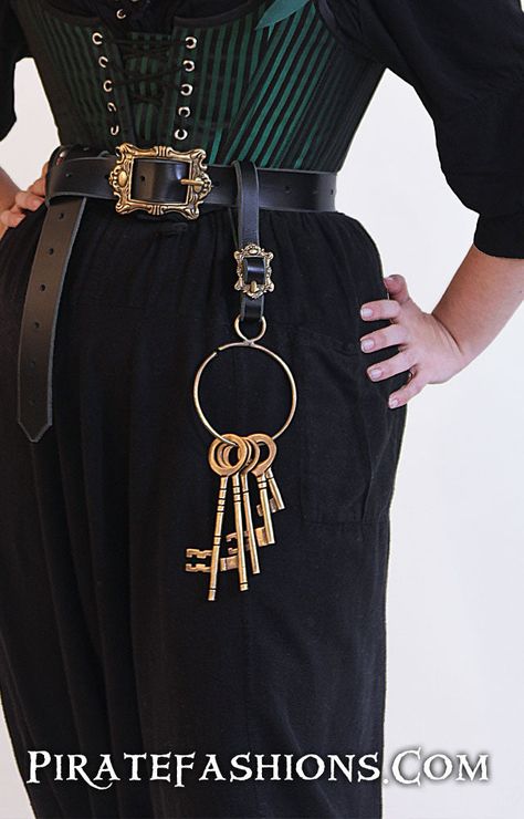 Need to have a little more flair on yar belt? Maybe show other pirates who's in charge? Or taunt some prisoners with their escape safely stashed away on yar person? Here be our Prison Key Ring, which includes 5 unique Brass Keys on a ring. Antiqued brass finish Keys measure from 6.75" to 2.75" 3.5" diameter key ring, .75" diameter attach ring Key ring has small opening to take keys on and off ring Weighs .6 lb Attaches to a belt the best with our Tankard Strap Key Ring Aesthetic, Pirate Belt, Pirate Garb, Pirate Wedding, Pirate Jewelry, Pirate Fashion, Black Beards, Corset Skirt, Pirate Woman