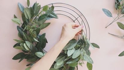 Decorate your home for every season with this simple DIY wreath. The artificial eucalyptus base is timeless and with the addition of seasonal silk flowers you can update your door decor throughout the year with this one handmade wreath. Step 1: Start by attaching the artificial eucalyptus (or any of your favorite faux greenery sprays) to the wire wreath form using floral tape. Step 2: Continue adding the greenery until the wire form is thoroughly covered. Step 3:… Wreath Making Party, Diy Floral Wreath, Silk Flower Wreaths, Fake Flower Arrangements, Make A Wreath, Green Leaf Background, Wire Wreath Forms, Homeschool Crafts, Wire Wreath Frame