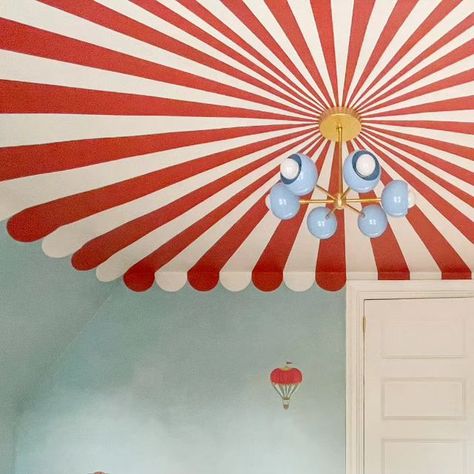 Sazerac Stitches on Instagram: "This circus themed nursery took a challenging ceiling shape and really made the most of it in the best way. We loved how Mom not only designed this room and painted the ceiling, but she also used our Loa Carousel to bring the tent to a center point. Hats off to mom! #sazeracstitches #nurserydesign #muralceiling #nurserymural #unisexnursery #maximalistinteriors #modernlighting" Circus Tent Painting, Circus Room, Girls Room Paint, Painted Trim, Ceiling Murals, Toddler Girl Room, Nursery Mural, Unisex Nursery, Sazerac