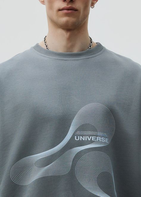 Unisex oversized sweatshirt, made with high-quality cotton, ensuring a soft and comfortable feels. Featuring a stylish print in the UNIVERSE edition. Material: 100% cotton three thread Model wears: L sizeModels height: 188 cm Universe Logo, Minimal Shirt Design, Comfort Clothing, Grey Man, T-shirt Print Design, Athleisure Men, Mens Shorts Outfits, French Terry Shorts, Men Sweatshirt