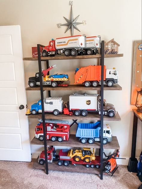 Car Toy Storage Ideas Playroom, Big Truck Toy Storage Ideas, Toy Truck Garage, Organizing Big Toy Trucks, Toy Truck Garage Storage, Big Toy Car Storage Ideas, Playroom Truck Storage, Organize Big Toy Trucks, Truck Storage Ideas Toy