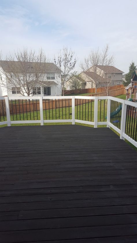 We foresee many fun family gatherings, days lounging in the sun, watching the kids play and grilling on this gorgeous deck. The white railings contrast beautifully against the rich stain of the deck painted in Black Aider SW 3022. Black Deck White Railing, Black Deck With White Railing, Black Alder Sherwin Williams, Black Alder Stain Sherwin Williams, Black Painted Deck, Black Deck Stain, Black Stained Deck, Black Decks, Black And White Deck