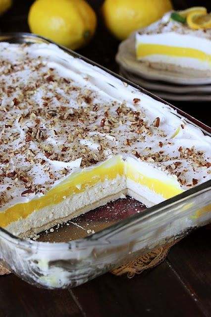 Lemon Lush in Baking Dish Cut to Show Layers Inside Image Keto Lemon Lush, Gluten Free Lemon Lush Dessert, Lemon Torte Desserts, Lemon Lush Dessert With Golden Oreos, Lemon Delight Dessert, Lemon Lush Cake, Peanut Butter Lush Dessert, Lush Cakes Dessert Recipes, Lemon Pretzel Dessert