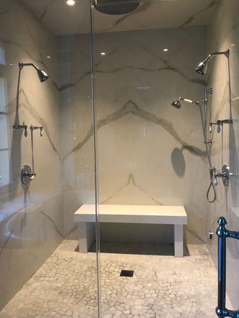 The updated shower features marble-inspired porcelain slabs, "book matched" so their vein patterns meet in dramatic arches on walls and ceiling. Book Matched Porcelain, Large Shower Tile, Granite Shower, Willow Oak, Master Bath And Closet, Kitchen Goals, Open Showers, Bath Redo, Amazing Showers