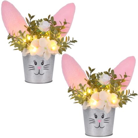 PRICES MAY VARY. Easter Table Decor: Our bunny artificial flower tabletop centerpiece is a nice addition to your Easter home decor. The plant pot is designed as a rabbit with plush bunny ears on the top, looks adorable and distinctive. Realistic Flowers: The flowers and leaves are lifelike and realistic, display the artificial flower in your home will make you feel closer to nature or Spring, it will add a perfect touch to your parties. LED Lights: There are several LED lights among the flowers, Little Christmas Trees, Decorations For Home, Easter Bunny Decorations, Spring Party, Easter Table Decorations, Bunny Plush, Bunny Ears, Easter Table, Easter Party