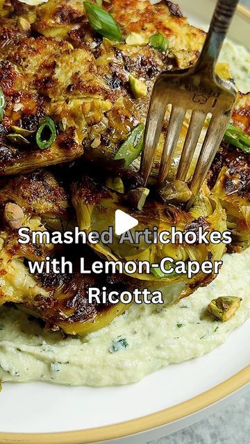 Caitlin Latessa-Greene on Instagram: "SMASHED ARTICHOKES WITH WHIPPED LEMON-CAPER-RICOTTA! Upgrading this favorite—they are tangy & crisp but tender with a lemon-caper herbed dip!
•
For the whipped ricotta:
1 cup ricotta
1/2 tsp dried dill
2 tbsp fresh parsley
1/2 tbsp capers
1/2 tbsp olive oil
Zest of 1/2 lemon
Juice of 1/2 lemon
1 clove garlic
1/4 tsp salt
1/4 tsp pepper
•
For the artichokes:
2 14-ounce cans artichoke hearts, drained and patted dry
2-3 tbsp olive oil, divided 
1/2 tsp garlic powder 
1/2 tsp dried oregano 
1/2 tsp pepper 
1-2 tbsp parmesan cheese, optional 
•
Optional Toppings:
Crushed pistachios 
Honey
Chopped scallions 
•
1️⃣Preheat the oven to 400. Line a sheet pan with parchment paper and set aside. 
Add the artichokes to a bowl with 1 1/2 tbsp olive oil, 1 tbsp Parme Smashed Artichoke Hearts With Lemon Caper, Smashed Artichoke Hearts, Artichokes Recipes, Canned Artichoke, Crushed Pistachios, Roasted Beets And Carrots, Dried Dill, Whipped Ricotta, Ricotta Recipes