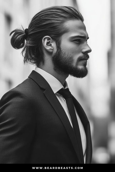 Side profile of a stylish man with a well-groomed beard and a sleek low ponytail, wearing a tailored suit and tie. One of the best men's hairstyles for long hair. Man With Beard Side Profile, Mens Ponytail, Ponytail Side Profile, Male Ponytail, Long Men’s Hair, Men Long Hair Bun, Best Long Haircuts, Well Groomed Beard, Guy Haircuts Long