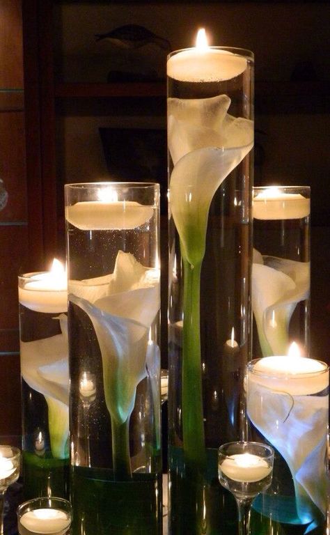 Calla Lillies submerged in cylinder vases with floating candles   I love how they appear magnified. Calla Lillies Centerpieces, Candles And Flowers, Rustic Wedding Decorations, Budget Friendly Wedding, בר מצווה, Deco Floral, Floating Candles, Glass Vases, Centre Pieces