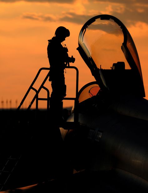 A Royal Air Force Typhoon pilot enters the cockpit as the sun sets Air Force Images, Aviation Image, Air Force Pilot, Military Helicopter, Aviation Photography, Fighter Pilot, Sun Sets, Southern Italy, Royal Air Force