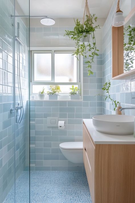 Discover sleek functionality and serene aesthetics with these modern bathroom ideas! Soft blue tiles and natural wood finishes create a calm, spa-like atmosphere. Perfect for small spaces. #ModernBathroomIdeas #InteriorDesign #HomeDecor Small Bathroom Ideas Blue Tile, Light Blue Tiled Bathroom, Bathroom Ideas With Blue Tile, Blue And Wood Bathroom Ideas, Small Light Blue Bathroom, Light Blue Tile Bathroom Ideas, Bathroom Color Tiles, Bathroom Ideas Terrazzo, Blue Spa Bathroom