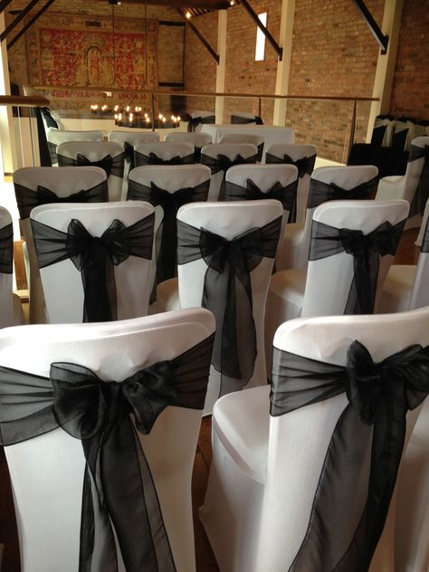 White chair covers with elegant black sashes for a #weddingceremony Black And White Wedding Chairs, Black Chair Sashes Wedding, Formal Party Decorations, Black Chair Covers Wedding Reception, Black Chair Covers Wedding, White Chair Covers With Black Sash, Black Chair Cover Gold Sash, White Chair Cover With White Sash, Black Wedding Chair Covers