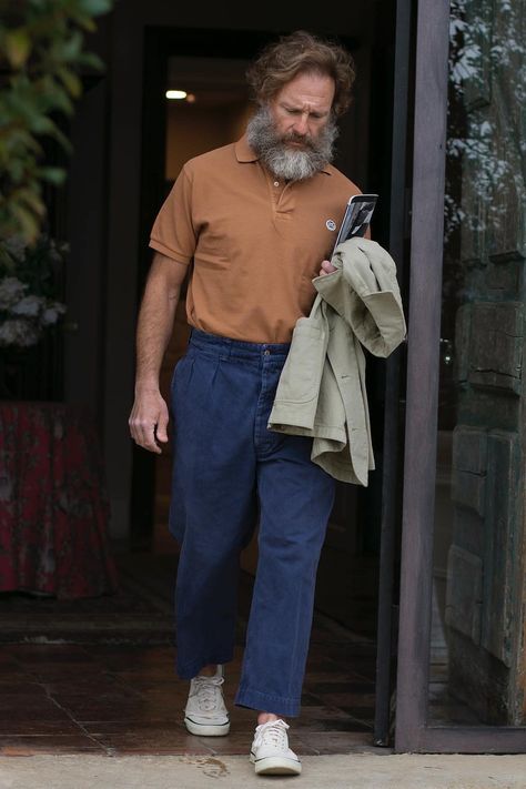 Man wearing blue pleated pants, tucked in brown polo shirt and khaki unstructured jacket with canvas low top sneakers. This image was included in the article: 16 Spanish Fashion Brands All Stylish Men Should Know, on MensFlair.com Spanish Men Style, Polo Shirt Outfit Men Street Styles, Tucked In Shirt Outfit, Brown Polo Shirt, Polo Shirt Outfit Men, Brown Polo, Unstructured Jacket, Polo Shirt Outfits, Shirt Outfit Men