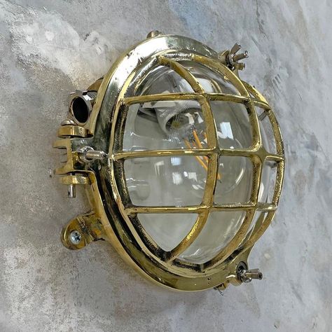 A vintage industrial cast brass circular bulkhead wall light with cast brass cage and glass domed shade.  originally marine lighting, this type of aluminium circular bulkhead is found on ship passageways. Professionally restored and rewired by hand in uk ready for modern use.  this piece has an attribution mark,   i am sure that it is completely authentic and  take full responsibility for any authenticity   issues arising from misattribution, up to 250v (europe/uk standard).the wiring of this it Industrial Brass, Bulkhead Wall Light, Vintage Industrial Lighting, Nautical Lighting, Bulkhead Light, Metal Wall Light, Bulkhead Lights, Industrial Light Fixtures, Industrial Wall Lights