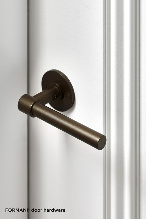 Close-up of a modern bronze door handle on a sleek white door. Bronze Door Hardware, Bronze Door, Architectural Projects, Bronze Finish, Door Hardware, Classic Design, Satin, Architecture, Design