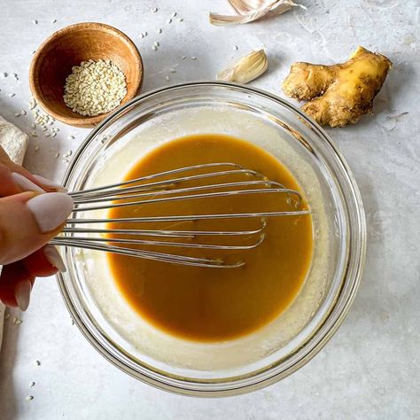 This Sesame Ginger Dressing is a creamy dressing for salads or marinade. A flavor balance of savory, nutty, and sweet. Vegan, Nutrient-Dense. Ginger Dressing Recipe, Thai Salad Dressings, Sesame Ginger Dressing, Healthy Dressing, Marinated Chicken Thighs, Ambitious Kitchen, Sesame Ginger, Ginger Dressing, Healthy Salad Dressing