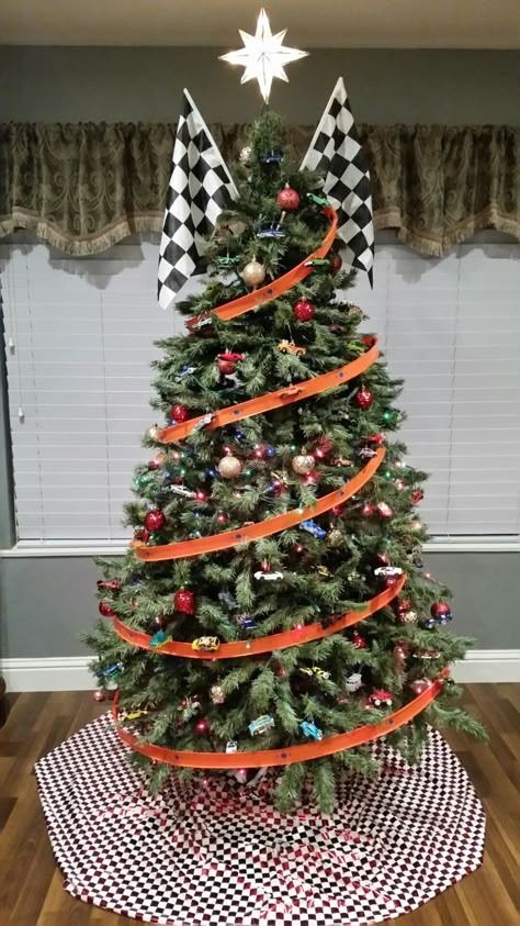 Handcrafted Hot wheels into ornaments with my husband and our boys. Over 100 specially chosen Hot Wheels to treasure as ornaments. We used Hot Wheels Tracks as garland. Checkered flags and red checkered skirt. Loving, enjoying and creating memories! Hot Wheels Ornaments Diy, Hot Wheels Tree Christmas, Hot Wheel Christmas Tree, Race Car Christmas Tree Ideas, Hotwheels Christmas Tree Ideas, Car Themed Christmas Tree, Hot Wheels Christmas Tree Ideas, Monster Truck Christmas Tree, Race Car Christmas Tree