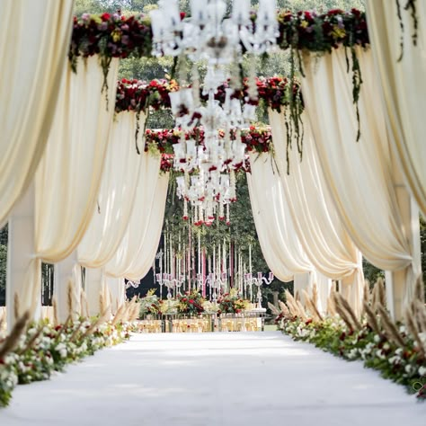 Enter a realm of timeless elegance with our white-themed decoration at the entrance, where simplicity meets sophistication. The pristine white decor elements create a serene and inviting atmosphere, setting the tone for a memorable celebration. From cascading floral arrangements to delicate drapery and soft lighting, every detail is meticulously designed to enchant and captivate. As you step through this elegantly adorned entrance, you embark on a journey into a world of beauty and romance, m... Walkway Decor Wedding, Wedding Entrance Arch Decor, Wedding Entry Gate Decoration, Pathway Decor Wedding, Wedding Passage, Wedding Entrance Decoration, Mandap Setup, Reception Entry, Event Entrance Arch