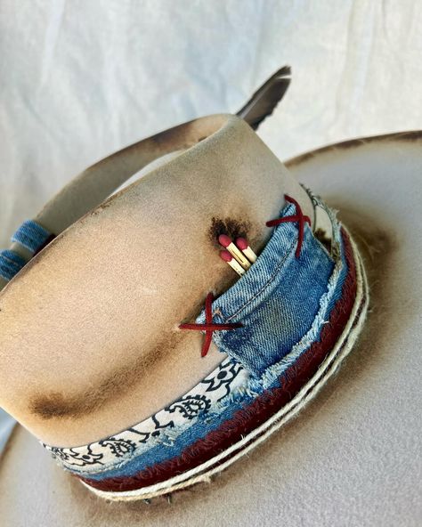 “Wrangler” Custom burned silver belly flat brim western hat with hand sewn details, matches, denim work, leather, bullet casing, twine and feathers. Quality wool felt hat with flat brim. One of a kind. Size: Small (6 7/8 - 7) $250 https://theroguecowpoke.etsy.com/listing/1793759836 Diy Wide Brim Hat, How To Burn Hats, Hat Band Ideas, Burned Felt Hat, Custom Hat Ideas, Hat Burning Ideas, Diy Leather Hat, Band Inspiration, Burned Hats